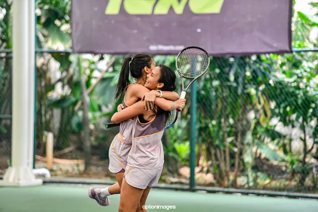 Two doubles partners hugging after winning their match